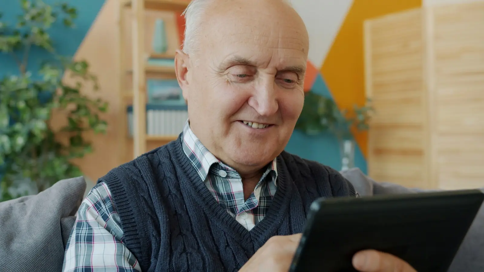 An older adult checking in with Lily on a tablet at home