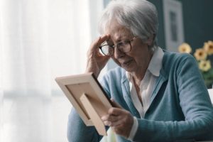 a woman looking at a picture frame