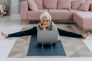 a woman sitting on the floor with a laptop