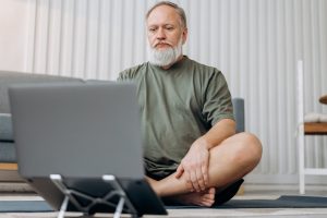 a man sitting on the floor with his legs crossed