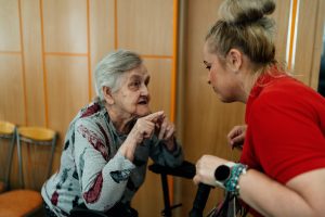 a woman talking to an older woman