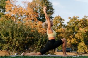 a woman doing yoga outside