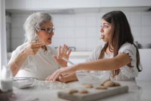 a woman and a girl in a kitchen