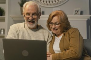 a man and woman looking at a laptop