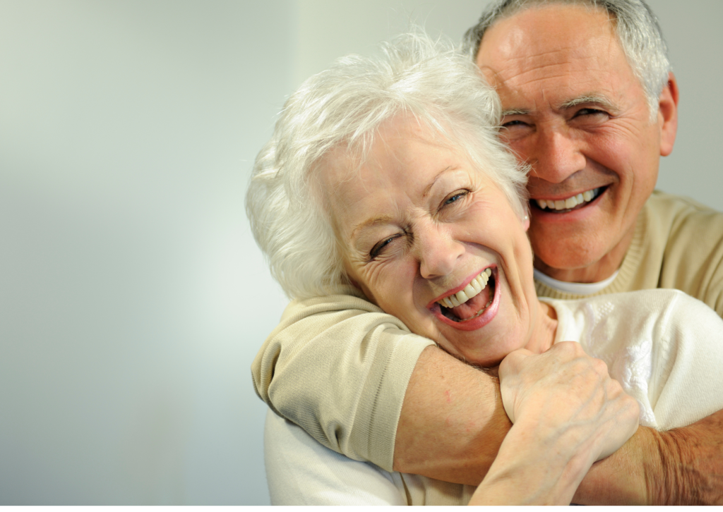 a man and woman hugging, happy with availing senior mental health services