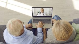 a man and woman looking at a laptop