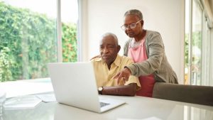 a man and woman looking at a laptop