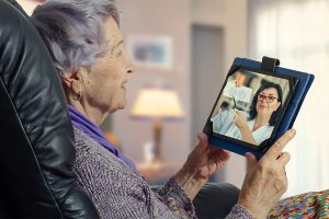 an older woman holding a tablet