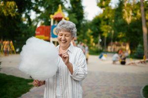 Smiling granny holds cotton candy