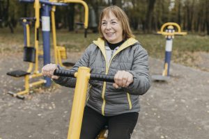 smiley older woman working out outdoors