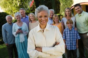 Senior woman celebrating with friends in garden