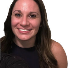 A smiling therapist from Total Life with long, wavy brown hair, wearing a dark top, photographed against a black background.