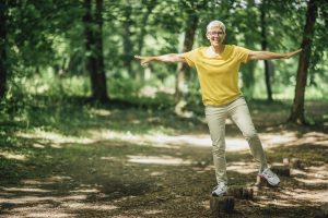 woman standing on one leg, exercising balance