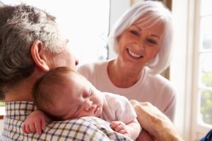 Grandparents Holding Sleeping Newborn Baby