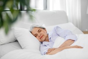 senior woman sleeping in bed at home