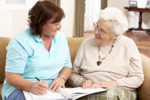 two ladies talking with papers