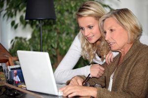 Younger and Older person looking at a computer