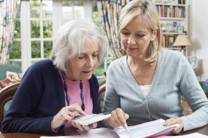 Woman Helping Older Person with Finances