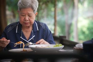 old elderly senior woman eating