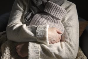 Older Adult holding hot water bottle