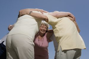 older people standing in a huddle