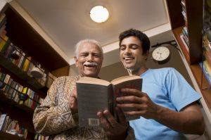 Father and son reading a book