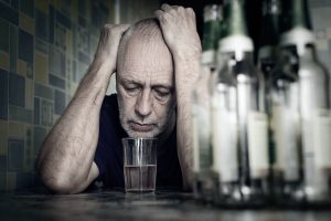 man falling into depression and becoming alcoholic