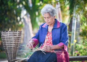 woman working on weave bamboo basket